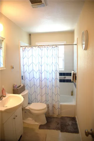 a bathroom with a toilet a sink and a shower