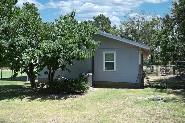 a house with trees in the background