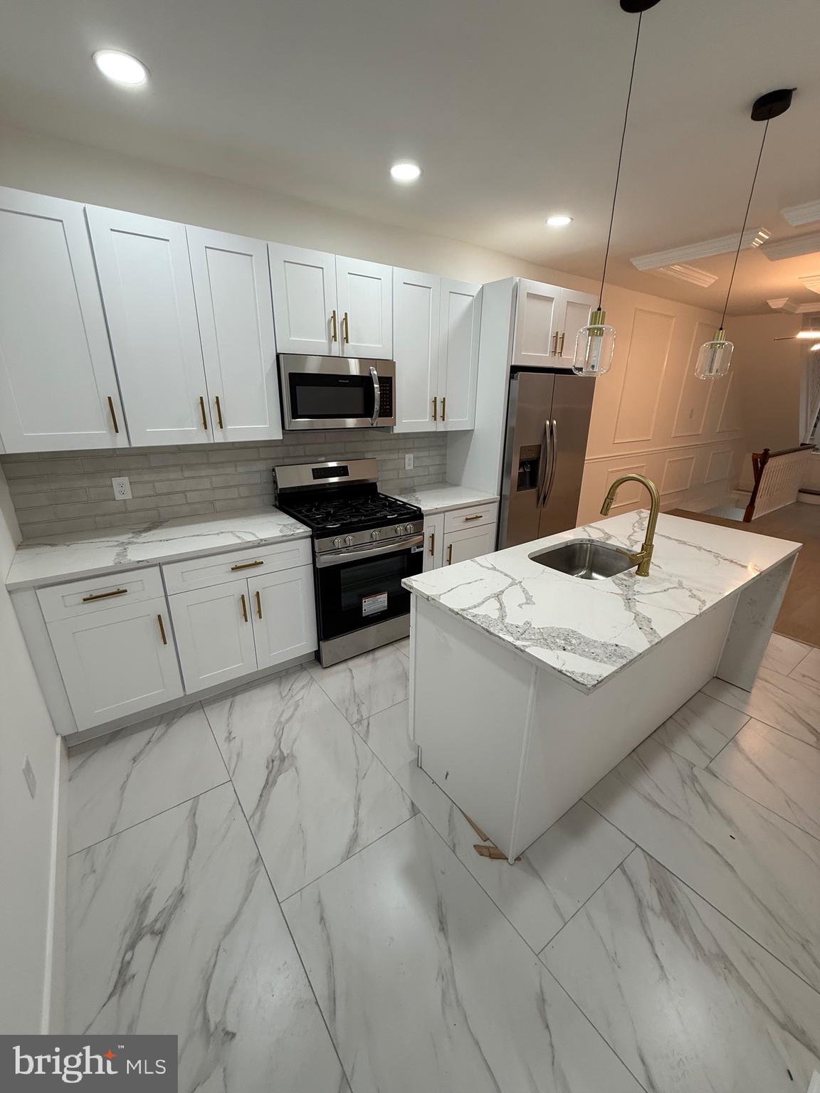 5908 Christian Street Philadelphia, PA 19143 - Photo 11 of 41 a kitchen with stainless steel appliances kitchen island granite countertop a sink and a stove