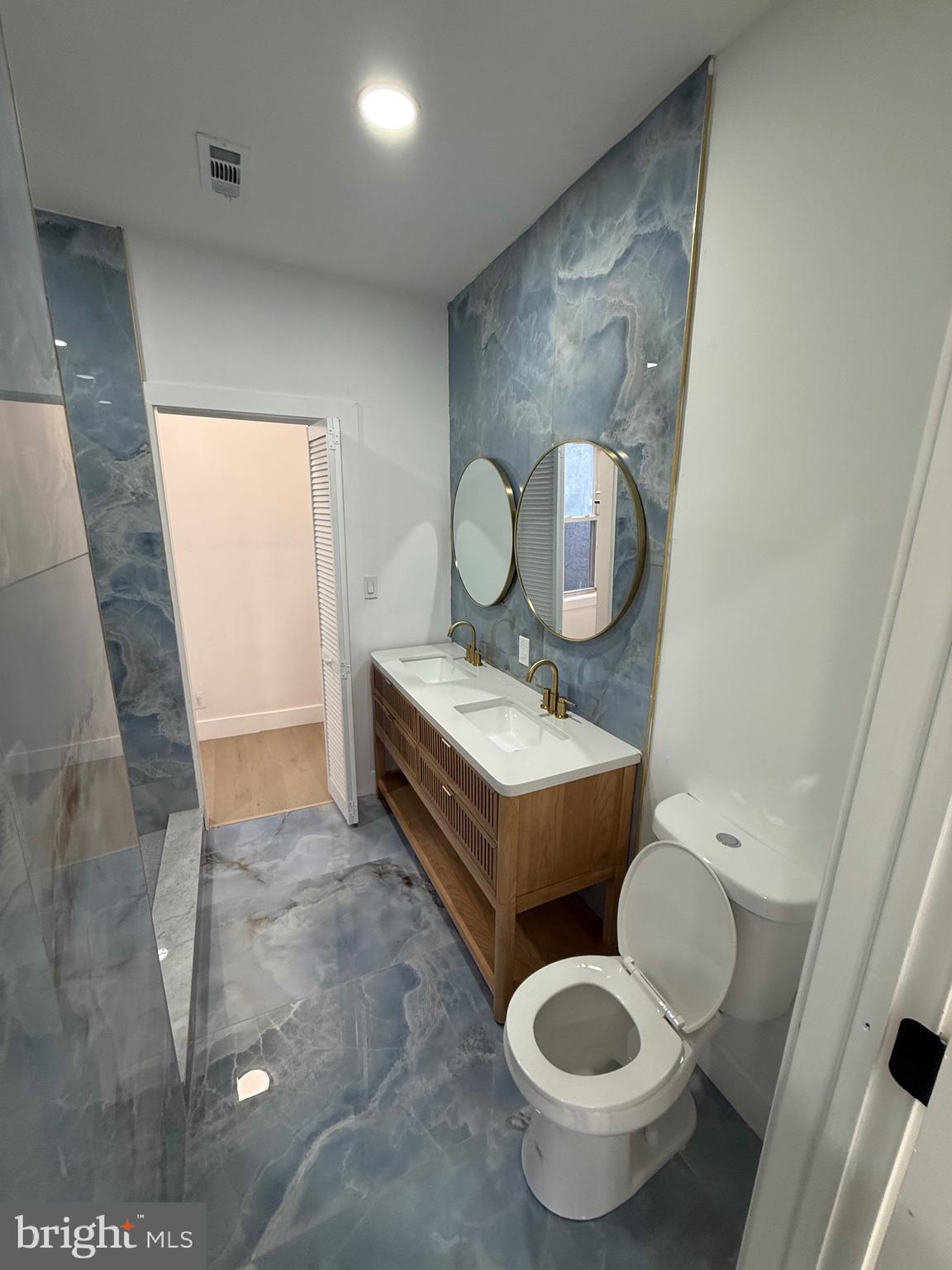 5908 Christian Street Philadelphia, PA 19143 - Photo 25 of 41 a bathroom with a granite countertop toilet and a sink