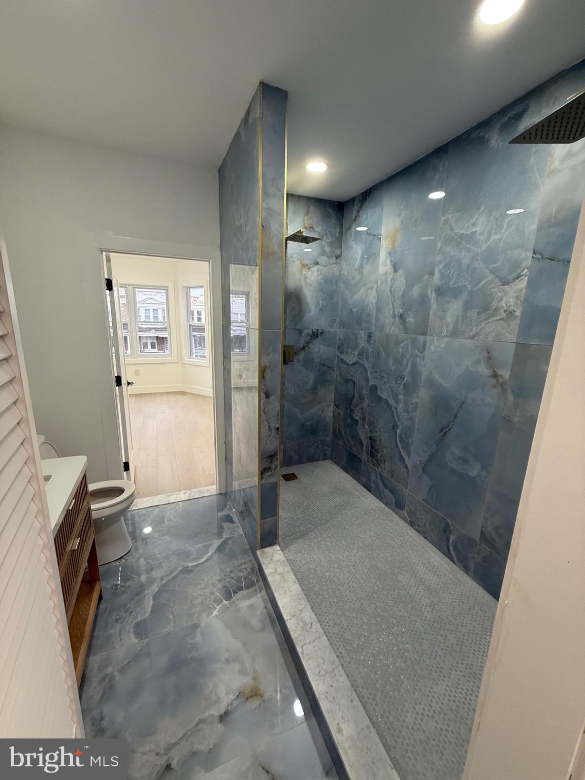5908 Christian Street Philadelphia, PA 19143 - Photo 26 of 41 a bathroom with a granite countertop sink a toilet and shower