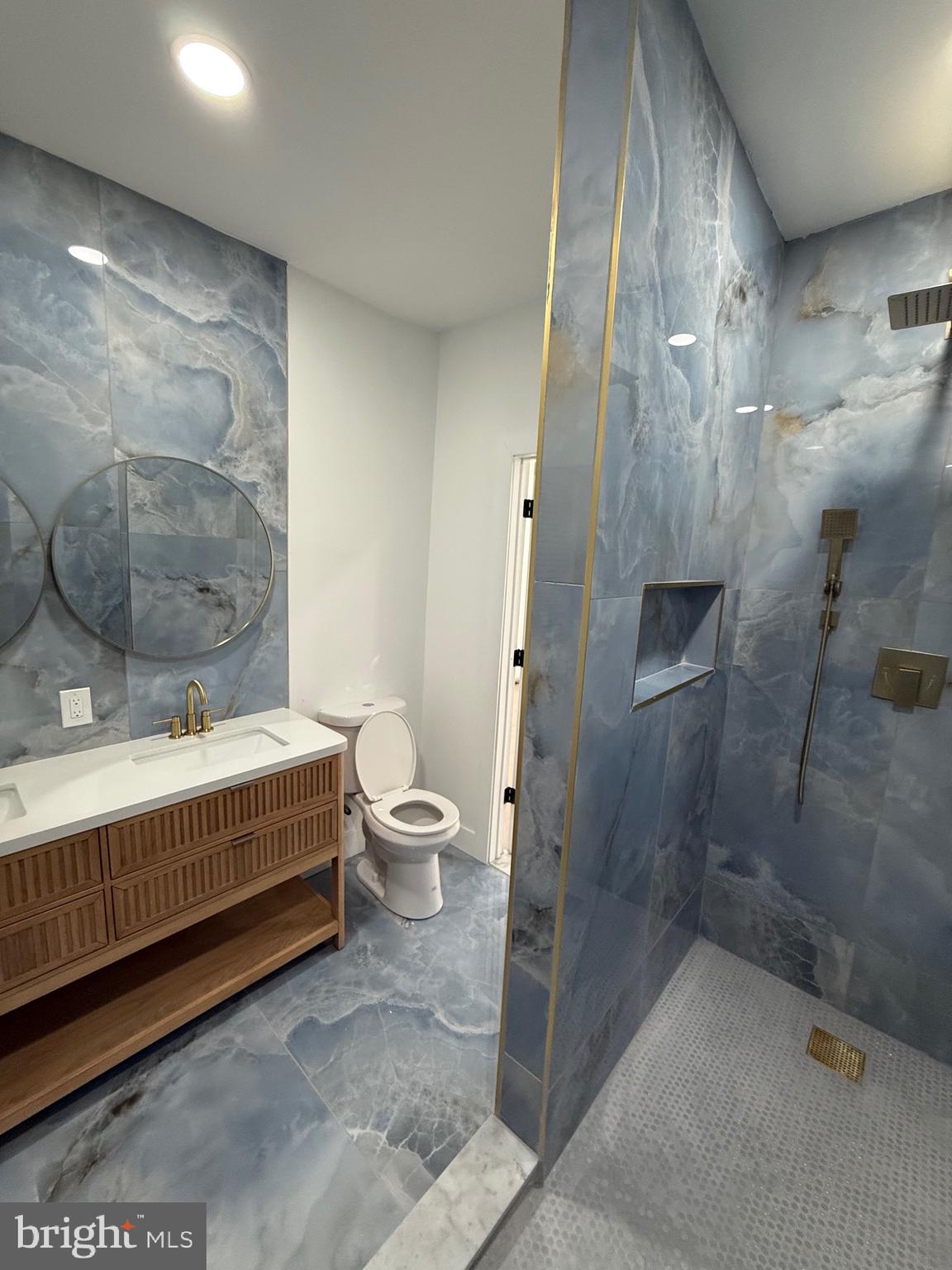 5908 Christian Street Philadelphia, PA 19143 - Photo 28 of 41 a bathroom with a sink and mirror with toilet