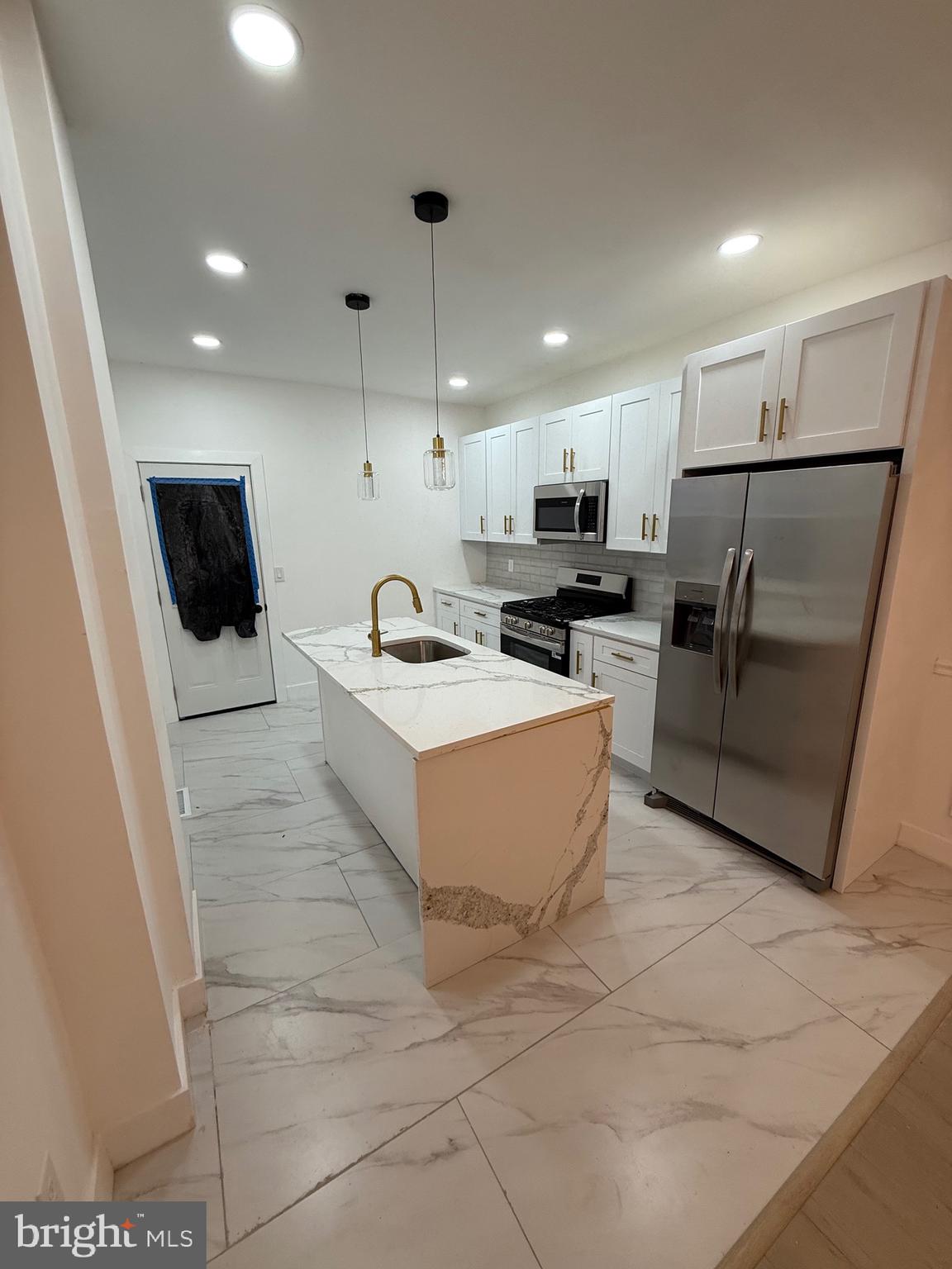5908 Christian Street Philadelphia, PA 19143 - Photo 10 of 41 a kitchen with stainless steel appliances a refrigerator and a sink