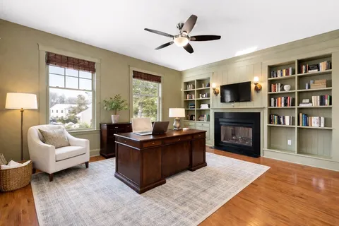 a living room with furniture fireplace and flat screen tv