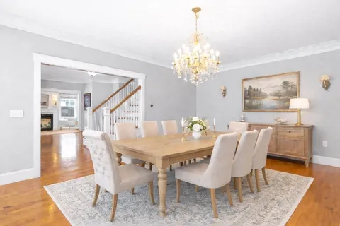 a view of a dining room with furniture and chandelier