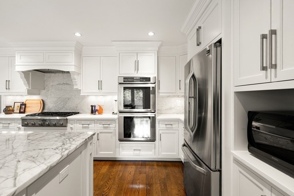 12 Puritan Road Newton, MA 02461 - Photo 3 of 39 a kitchen with stainless steel appliances granite countertop a refrigerator stove and sink