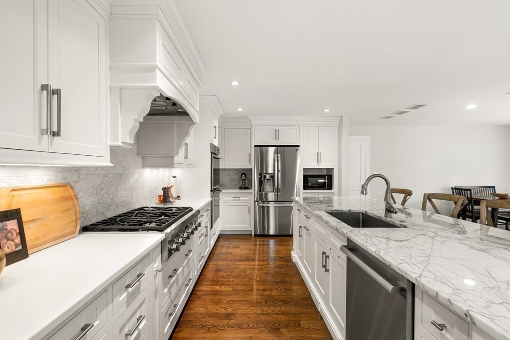 12 Puritan Road Newton, MA 02461 - Photo 4 of 39 a kitchen with stainless steel appliances granite countertop a sink a stove and a refrigerator