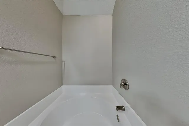 a bathroom with a white bath tub