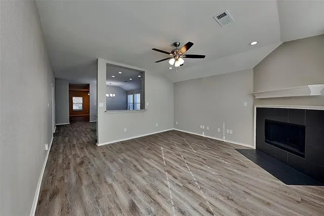 wooden floor in an empty room with a fireplace