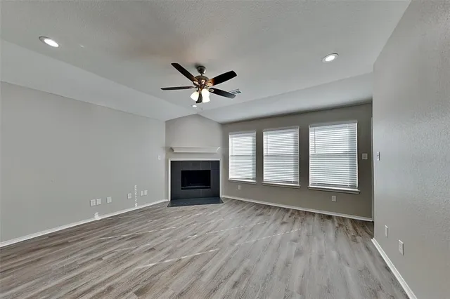 wooden floor in an empty room with a fireplace