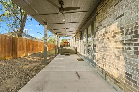a view of a street with wooden fence