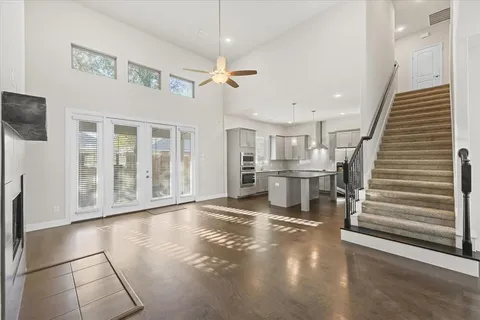 a view of a livingroom with wooden floor and stairs