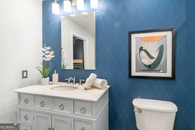 a bathroom with a sink vanity and a toilet