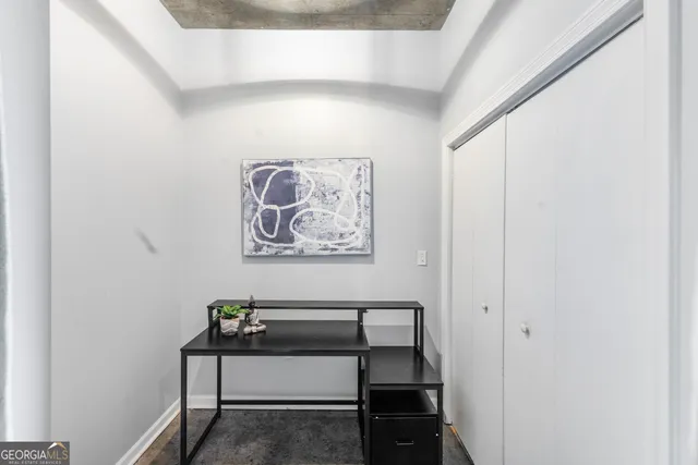 a view of a hallway with paintings on the wall