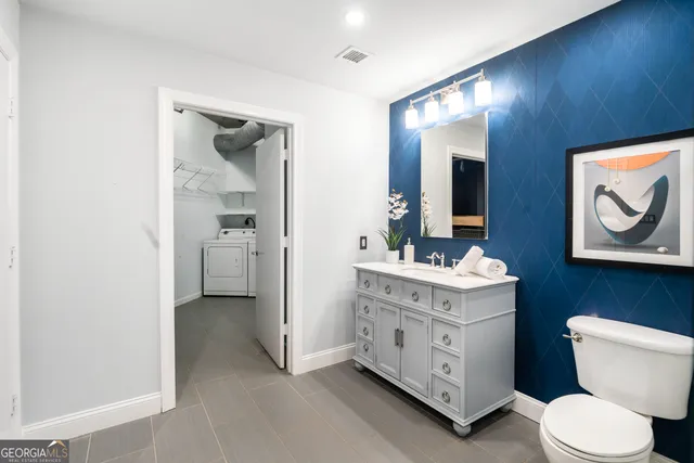 a bathroom with a toilet a sink and a mirror