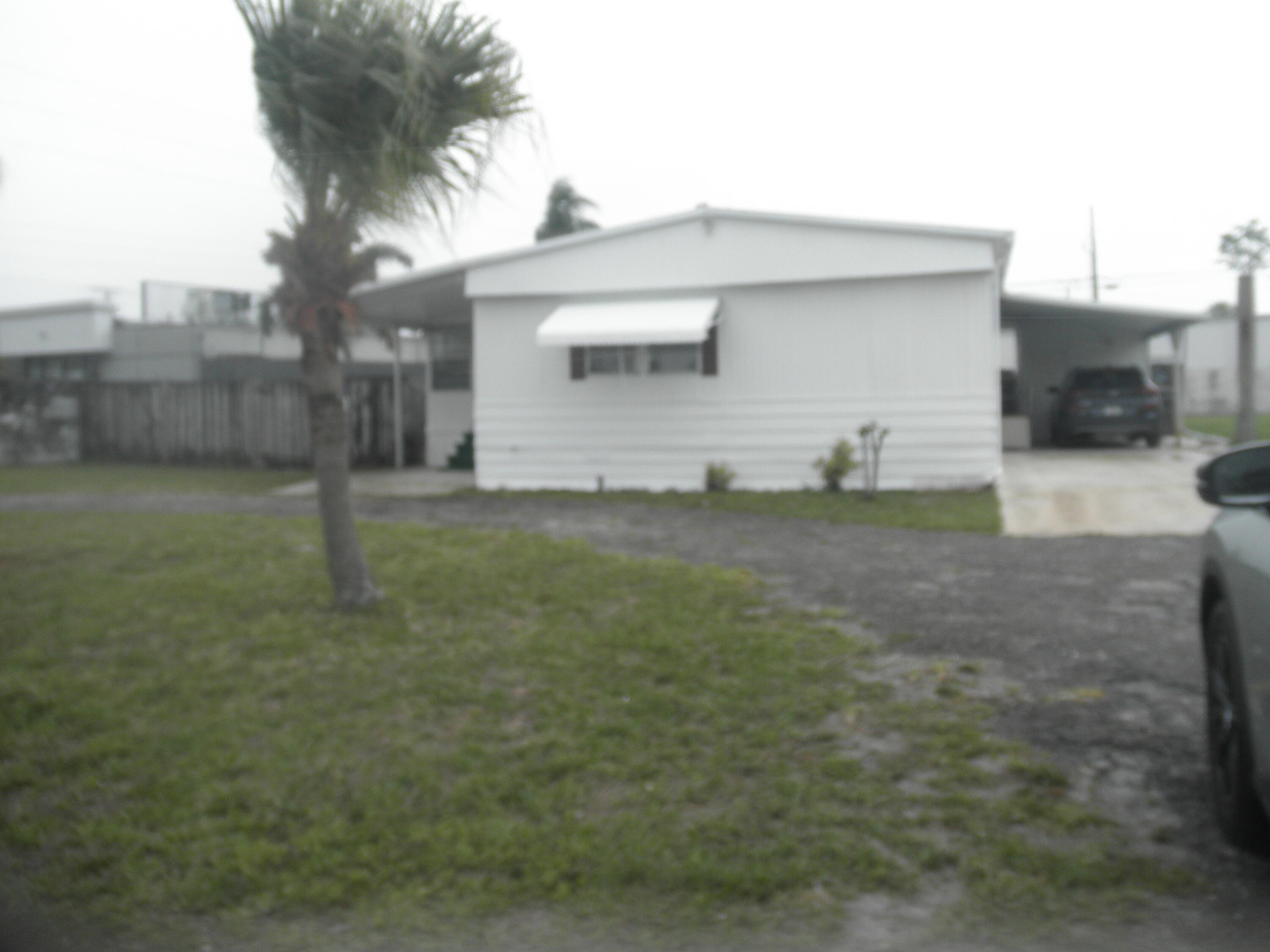 a view of a house with a yard and garage