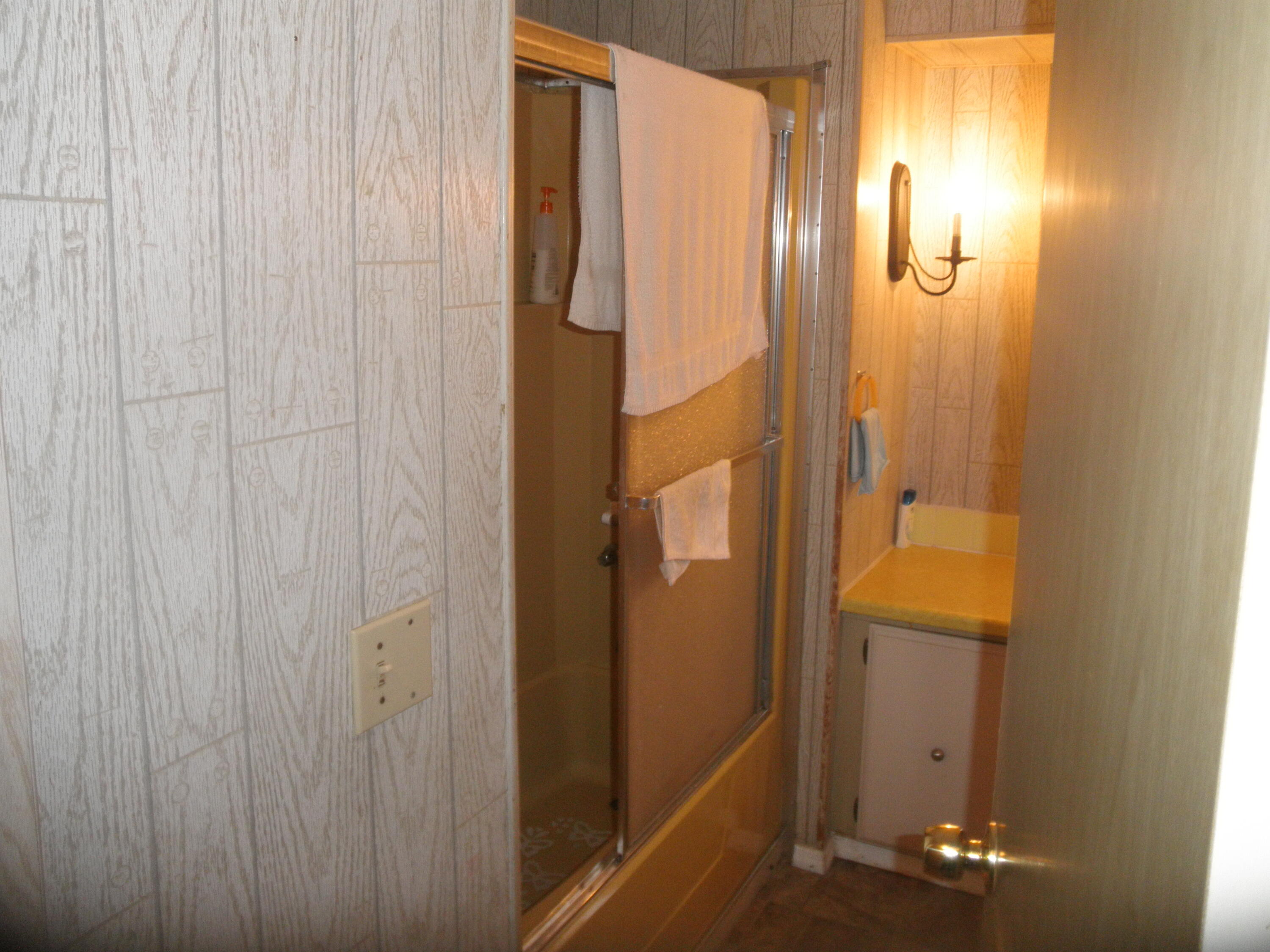 4544 Sunset Ranch Road West Palm Beach, FL 33415 - Photo 7 of 10 a bathroom with a shower and a door