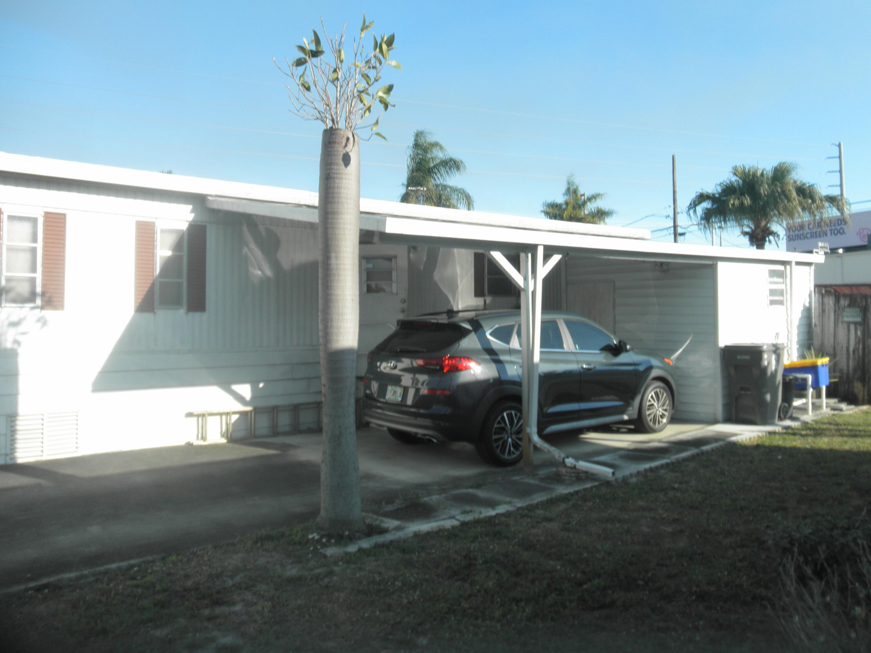 4544 Sunset Ranch Road West Palm Beach, FL 33415 - Photo 9 of 10 a view of a car park in front of a house