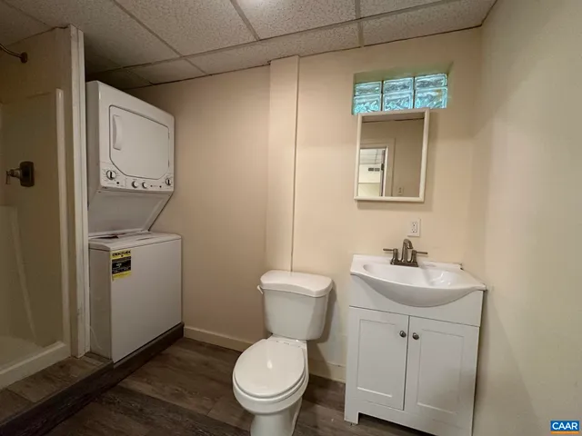 a bathroom with a toilet a sink and mirror