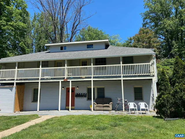 a view of a house with a yard and a garden