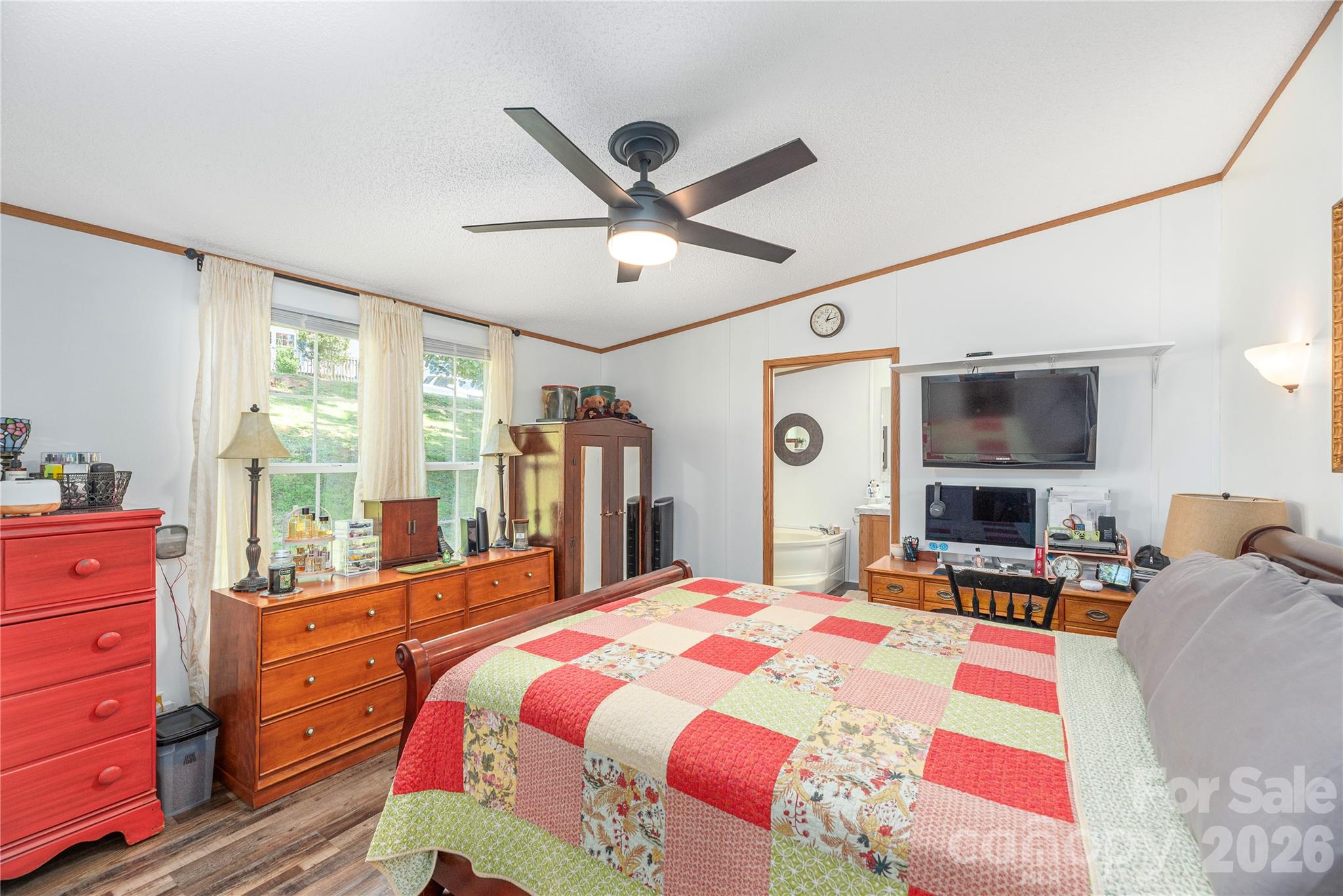 40 Farmstead Road Leicester, NC 28748 - Photo 12 of 29 a bedroom with a bed and large mirror with a flat tv screen