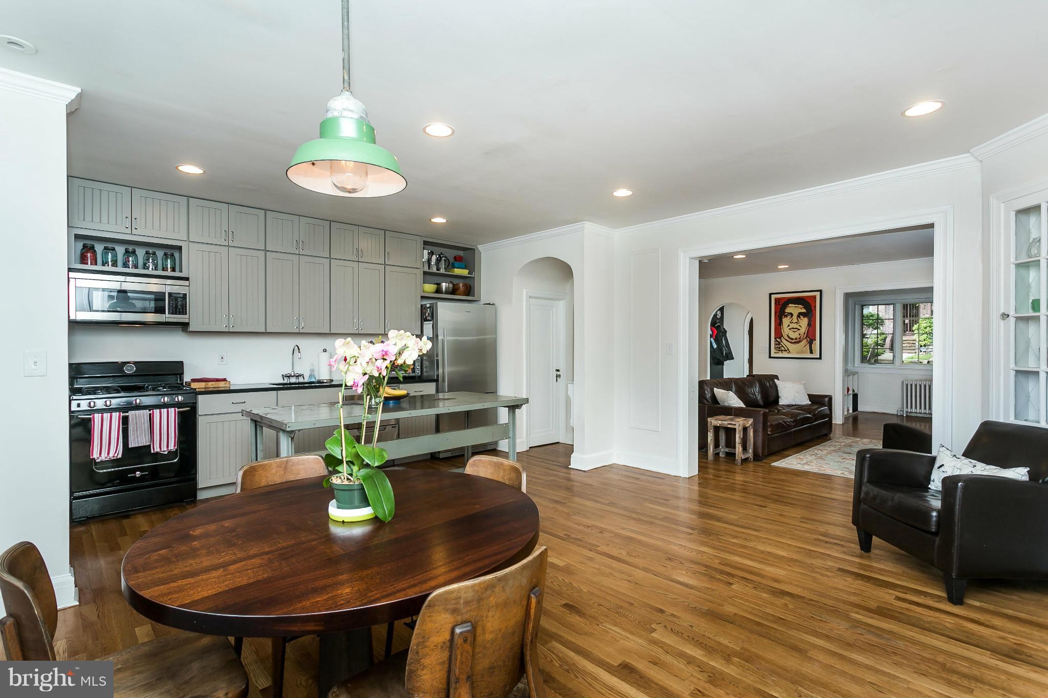 3713 Rexmere Road Baltimore, MD 21218 - Photo 14 of 30 a living room with stainless steel appliances kitchen island granite countertop furniture and a wooden floor