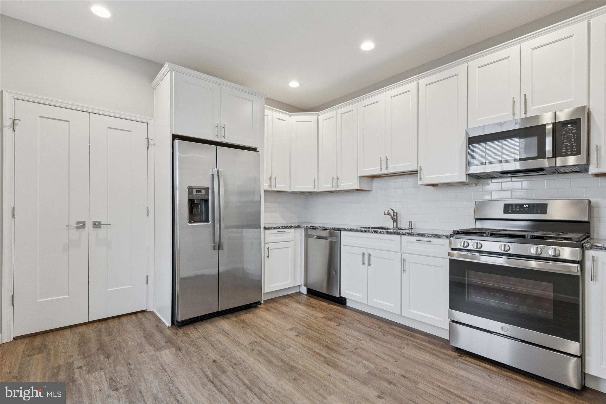 3238 Ridge Pike, Unit A Eagleville, PA 19403 - Photo 11 of 14 a kitchen with stainless steel appliances granite countertop a stove a refrigerator and a microwave