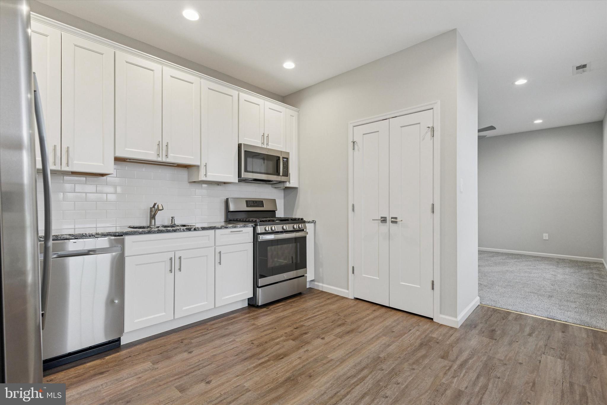 3238 Ridge Pike, Unit A Eagleville, PA 19403 - Photo 12 of 14 a kitchen with cabinets stainless steel appliances and wooden floor