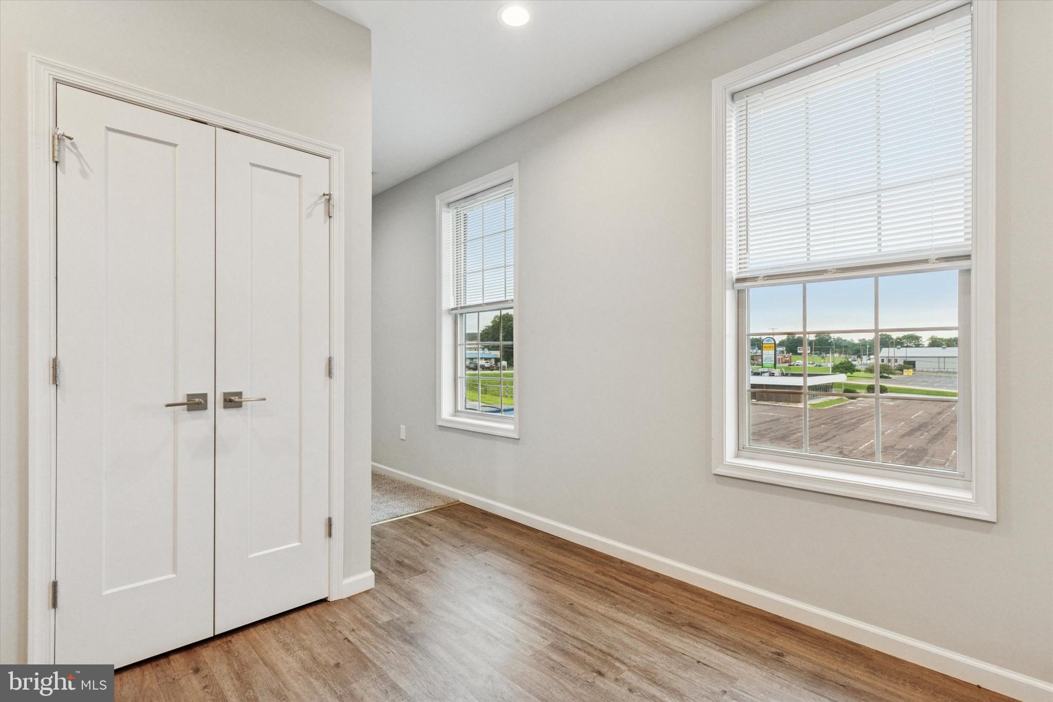 3238 Ridge Pike, Unit A Eagleville, PA 19403 - Photo 13 of 14 a view of an empty room with wooden floor and a window
