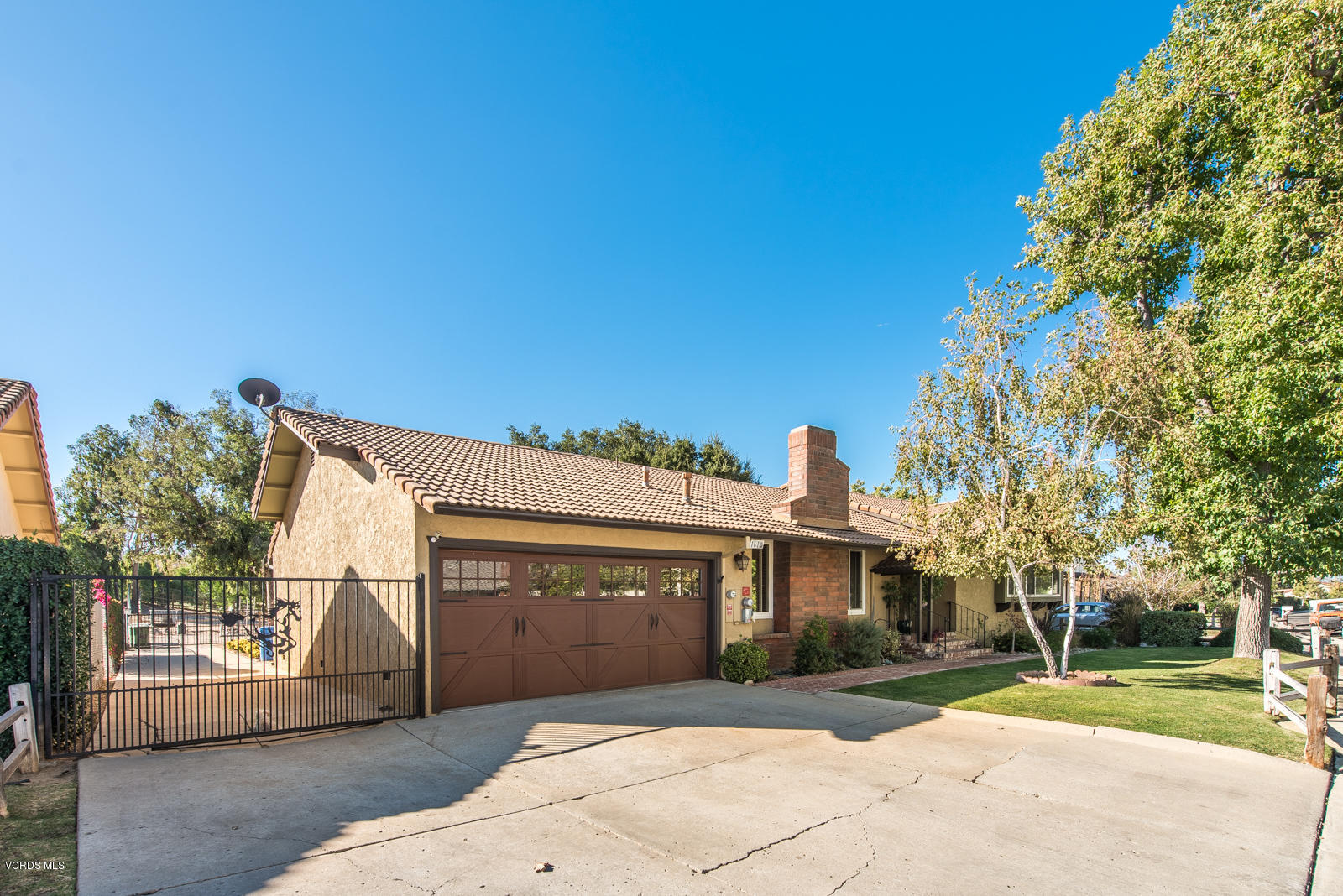 1610 Rambling Road Simi Valley, CA 93065 - Photo 2 of 26 a front view of a house with a yard and garage