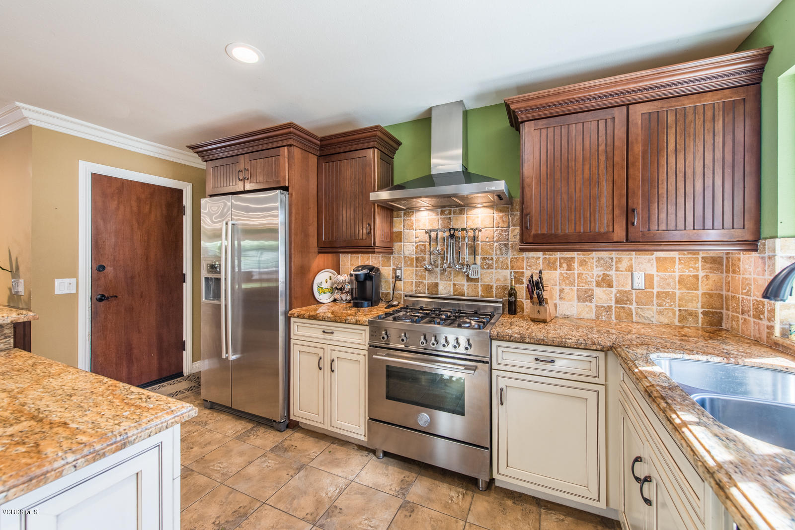 1610 Rambling Road Simi Valley, CA 93065 - Photo 11 of 26 a kitchen with granite countertop wooden cabinets and white appliances