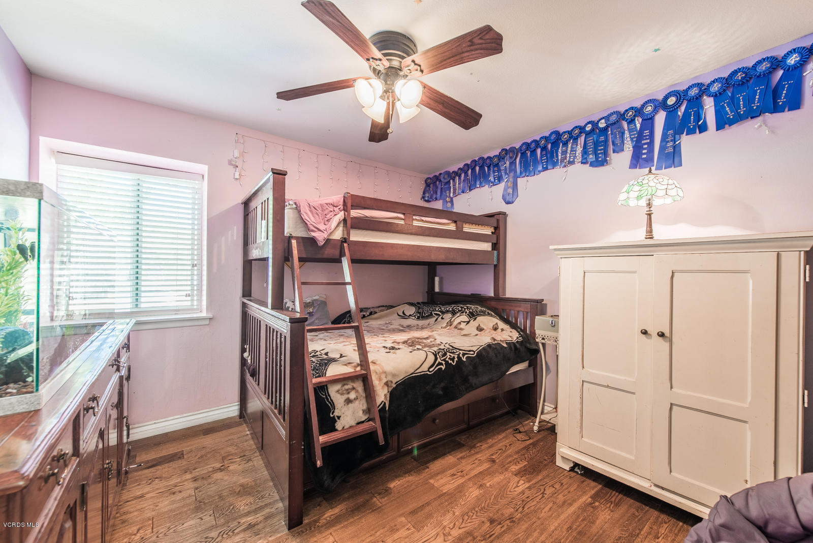 1610 Rambling Road Simi Valley, CA 93065 - Photo 16 of 26 a bedroom with a bed and a chandelier