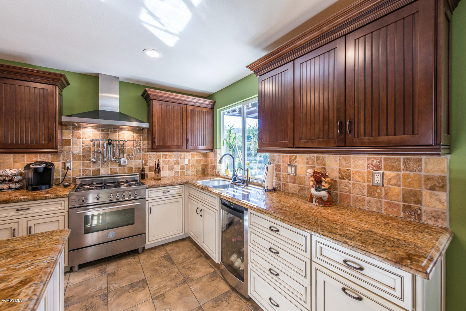 1610 Rambling Road Simi Valley, CA 93065 - Photo 10 of 26 a kitchen with stainless steel appliances granite countertop wooden cabinets a stove top oven a sink and dishwasher