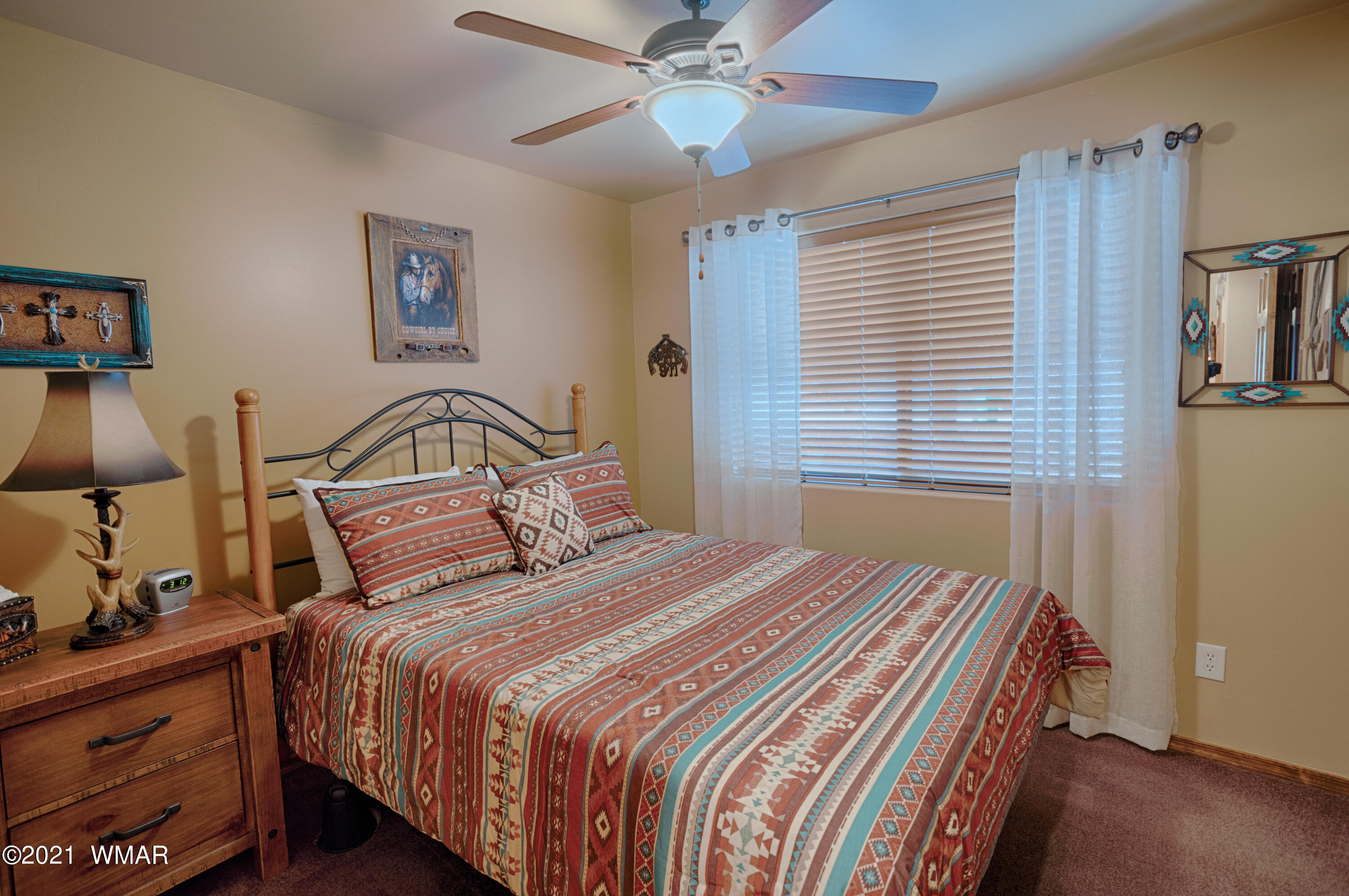 4861 West Cottage Loop Show Low, AZ 85901 - Photo 12 of 35 a bedroom with a bed and a chandelier