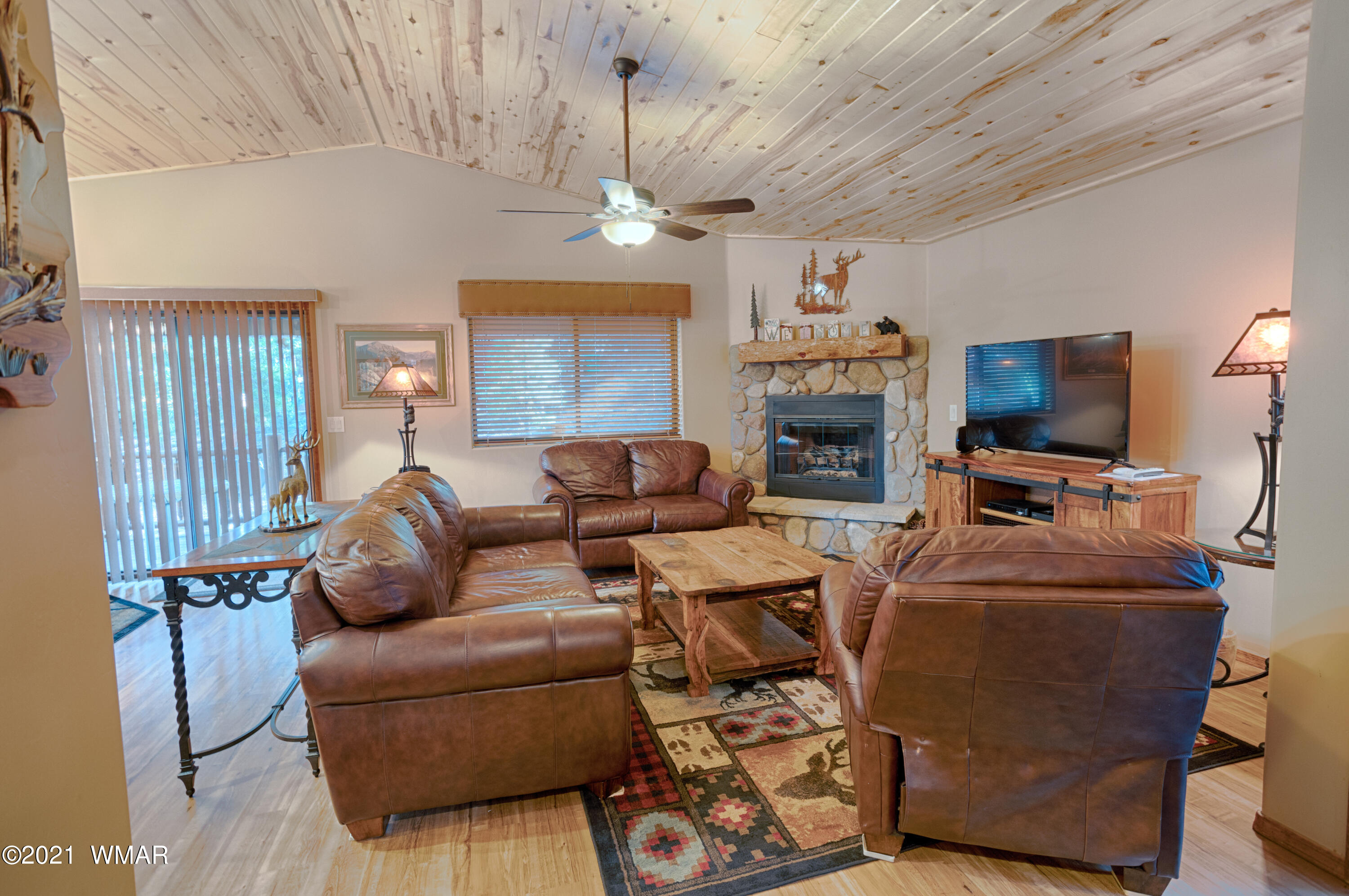 4861 West Cottage Loop Show Low, AZ 85901 - Photo 2 of 35 a living room with furniture a fireplace and a chandelier