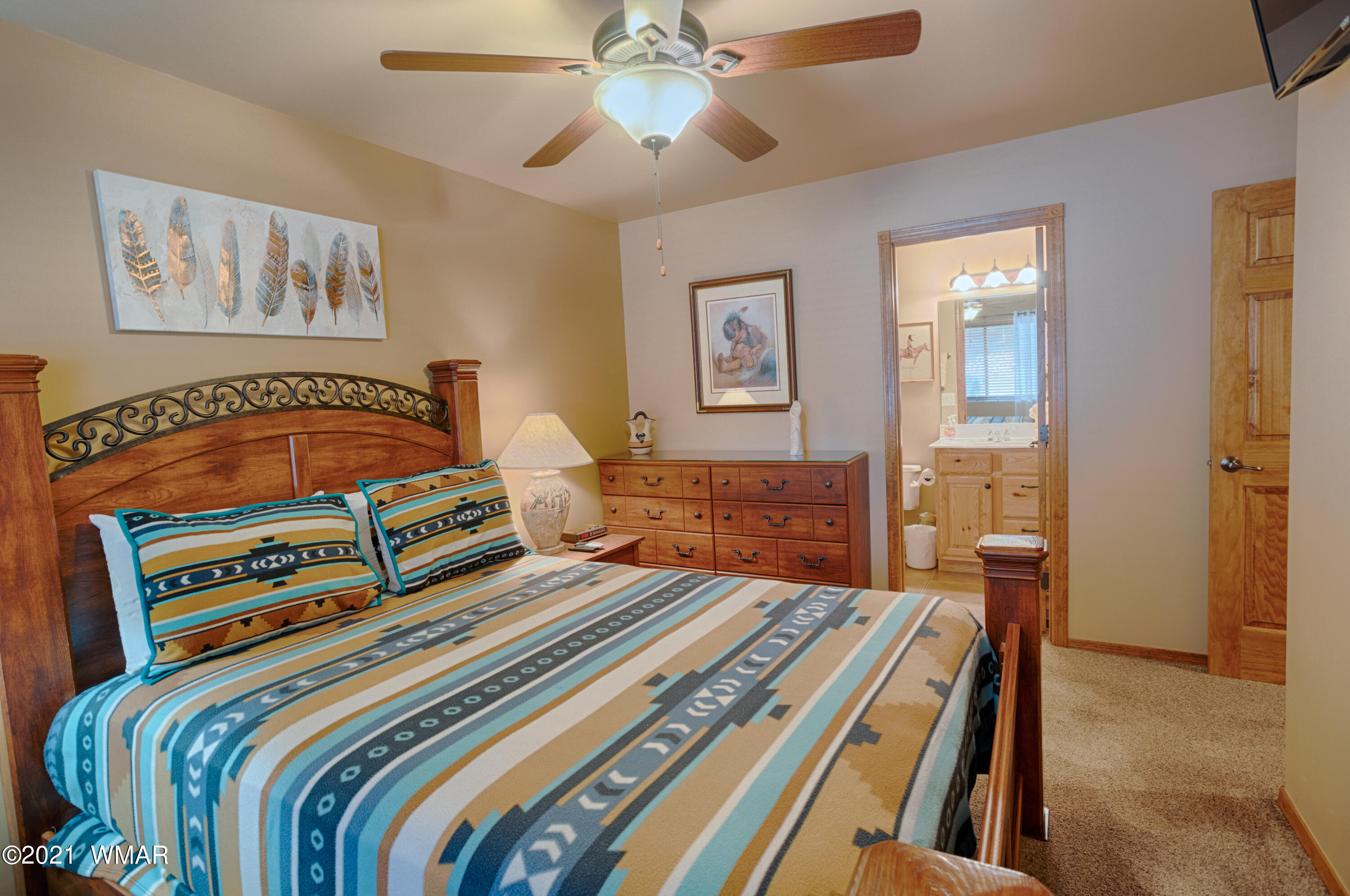 4861 West Cottage Loop Show Low, AZ 85901 - Photo 6 of 35 a bedroom with a bed and a chandelier