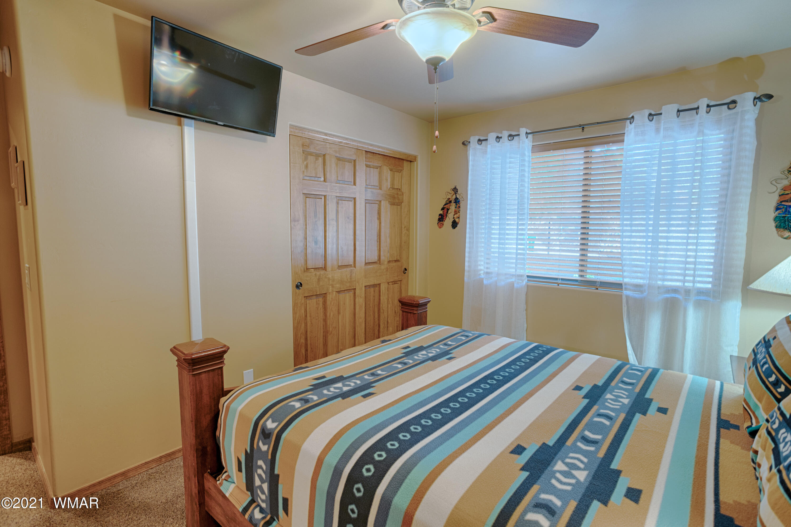 4861 West Cottage Loop Show Low, AZ 85901 - Photo 7 of 35 a bedroom with a bed and a flat screen tv