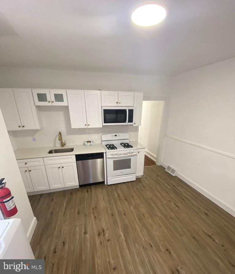102 Chestnut Street Audubon, NJ 08106 - Photo 2 of 15 a kitchen with stainless steel appliances a white stove top oven and white cabinets