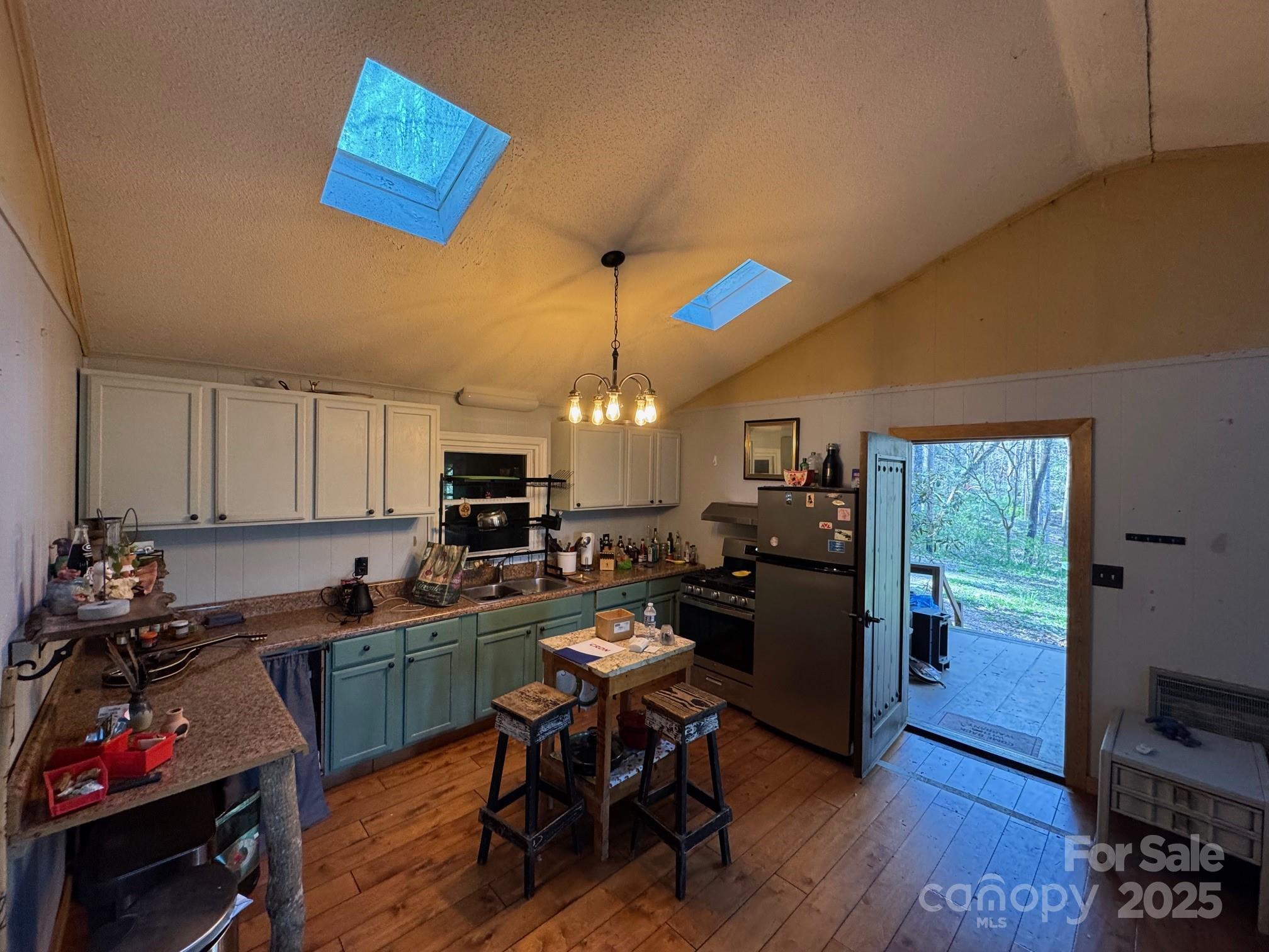 269 East View Road Sylva, NC 28779 - Photo 11 of 28 a kitchen with a refrigerator and a stove top open