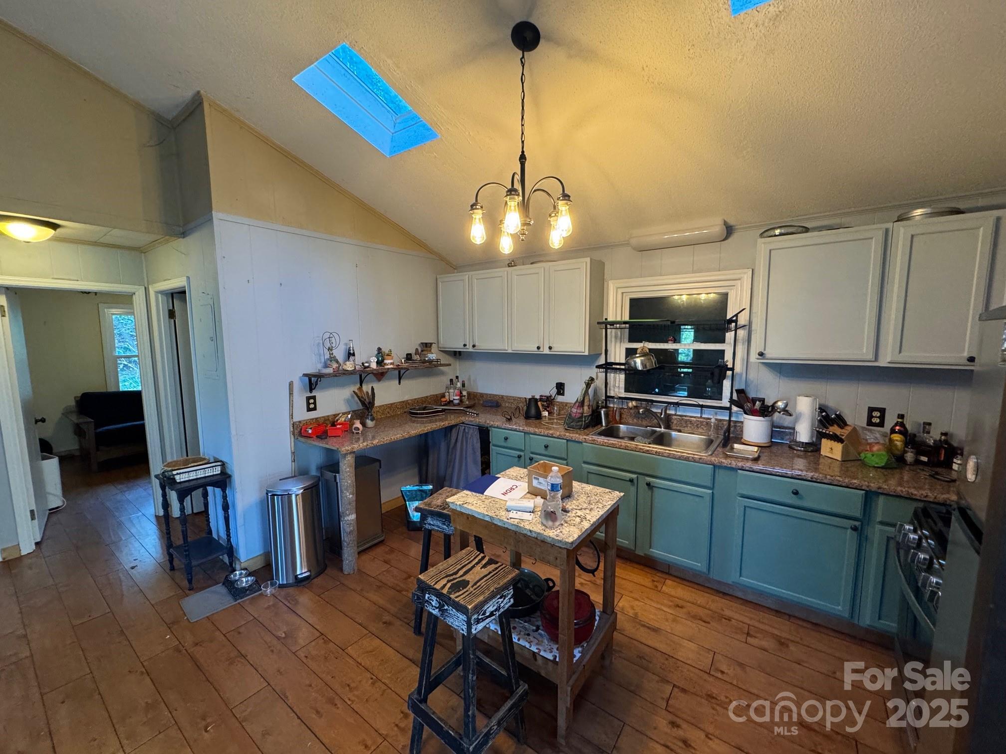 269 East View Road Sylva, NC 28779 - Photo 13 of 28 a kitchen with a dining table chairs stove and cabinets