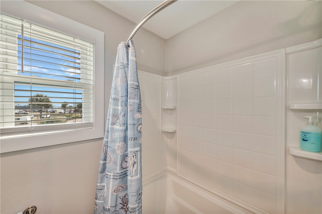 230 Cut-Off Road, Unit 204 Port Aransas, TX 78373 - Photo 19 of 37 a bathroom with a bathtub and shower
