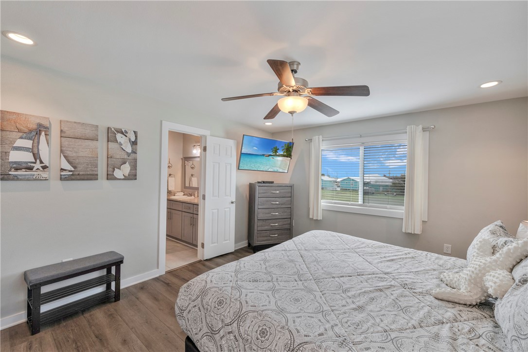 230 Cut-Off Road, Unit 204 Port Aransas, TX 78373 - Photo 22 of 37 a bedroom with a large bed and a window