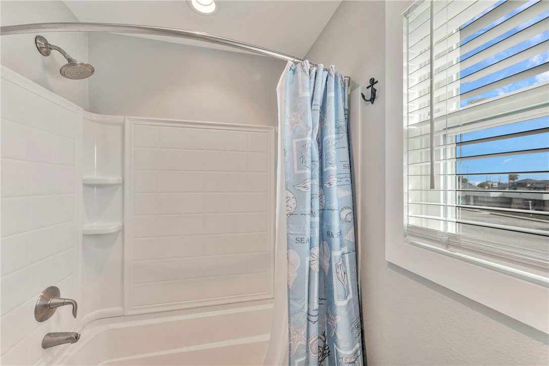 230 Cut-Off Road, Unit 204 Port Aransas, TX 78373 - Photo 24 of 37 a bathroom with a shower and a tub