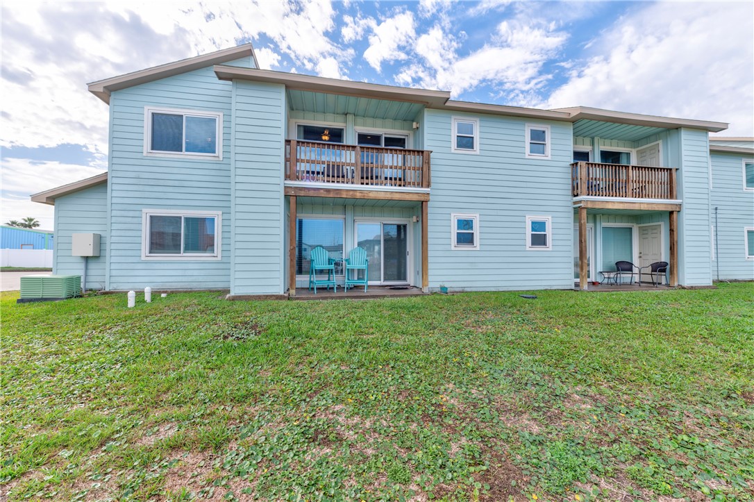 230 Cut-Off Road, Unit 204 Port Aransas, TX 78373 - Photo 28 of 37 a front view of a house with a garden