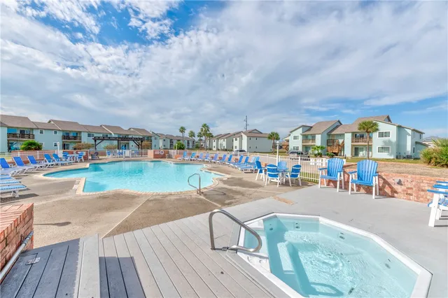 a swimming pool with outdoor seating and yard