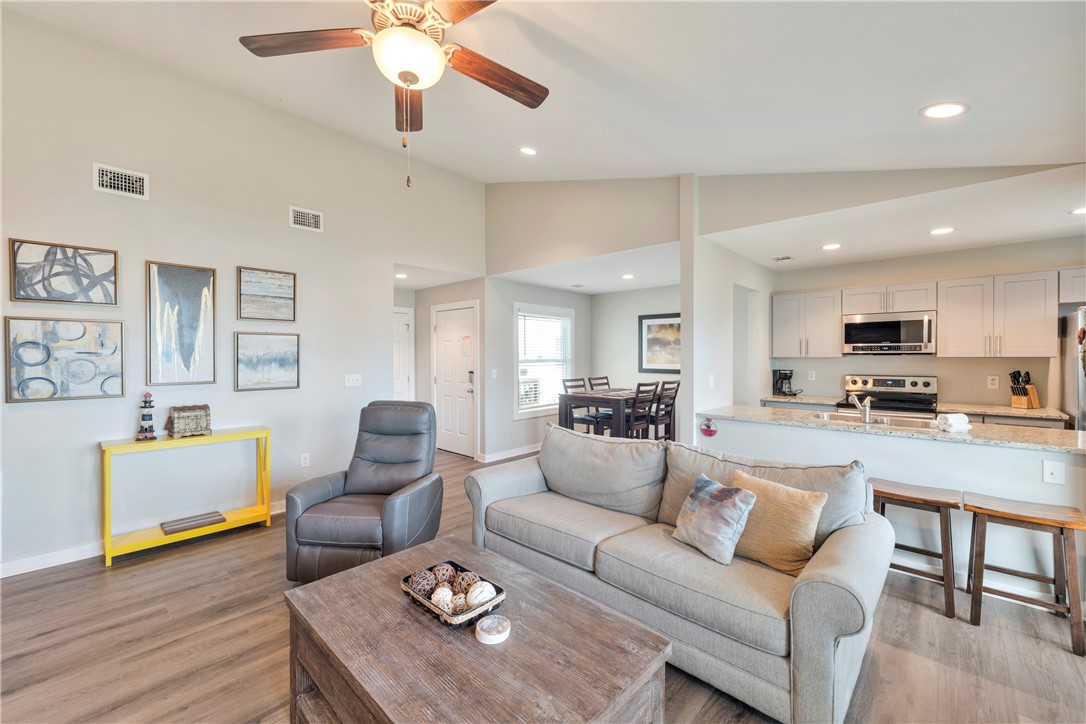230 Cut-Off Road, Unit 204 Port Aransas, TX 78373 - Photo 6 of 37 a living room with furniture kitchen view and a wooden floor