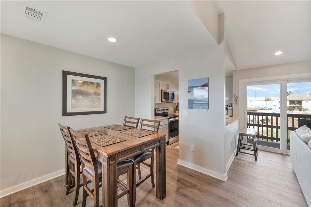230 Cut-Off Road, Unit 204 Port Aransas, TX 78373 - Photo 7 of 37 a view of a dining room with furniture and wooden floor