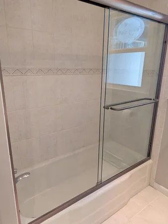 a bathroom with a glass shower door