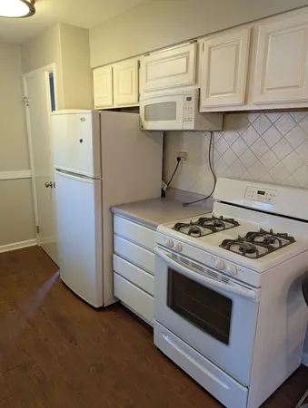 a kitchen with a stove and a refrigerator