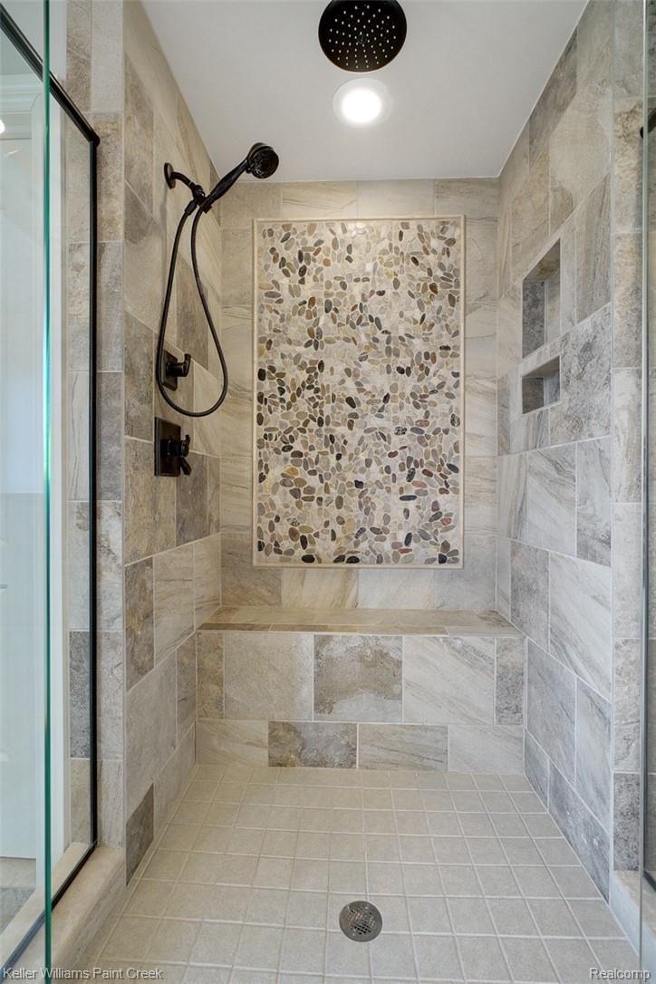 2888 North Addison Circle Rochester, MI 48306 - Photo 45 of 73 Exquisite tile features including a bench, custom stone inlay and niches enhance this huge walk in rain shower.
